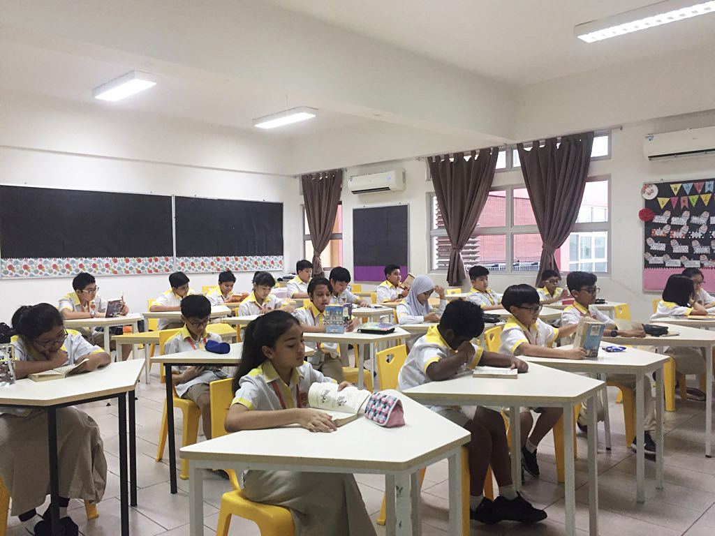 Students of Sekolah Rendah Rafflesia sitting on their classroom